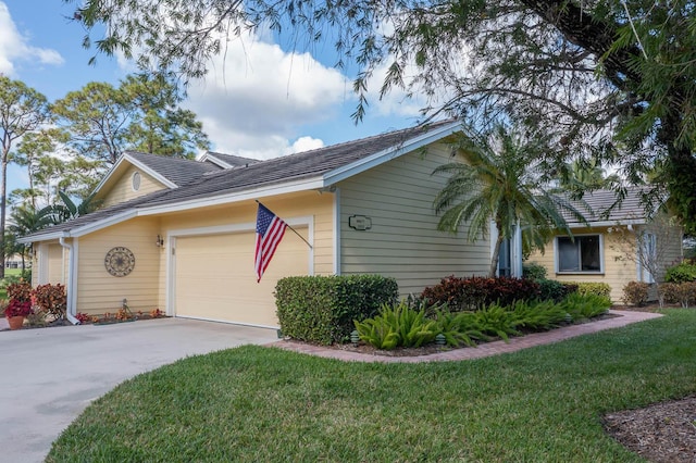 view of front of home featuring a garage and a front lawn