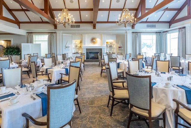 dining room with an inviting chandelier, beam ceiling, and high vaulted ceiling