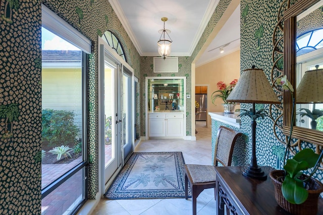 foyer with ornamental molding and light tile patterned floors