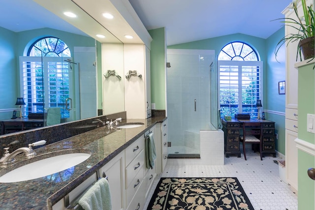 bathroom with vanity, lofted ceiling, and an enclosed shower