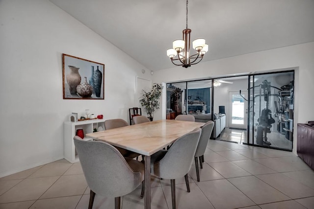 dining space featuring light tile patterned flooring, a chandelier, and vaulted ceiling