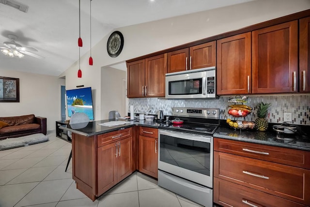 kitchen with lofted ceiling, a breakfast bar, hanging light fixtures, appliances with stainless steel finishes, and kitchen peninsula