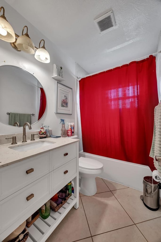 full bathroom with tile patterned flooring, vanity, toilet, a textured ceiling, and shower / bath combo with shower curtain