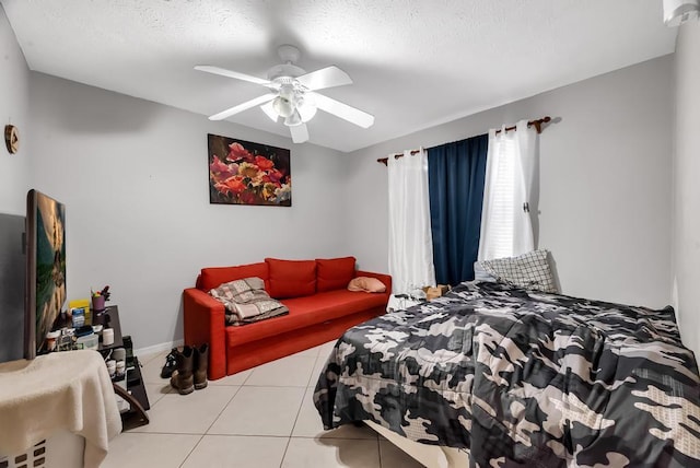 bedroom with light tile patterned flooring, a textured ceiling, and ceiling fan