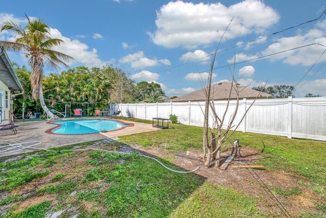 view of yard featuring a fenced in pool and a patio area