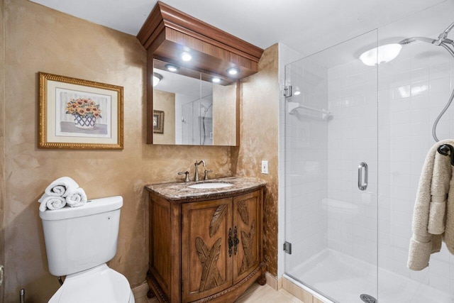 bathroom with toilet, walk in shower, and vanity