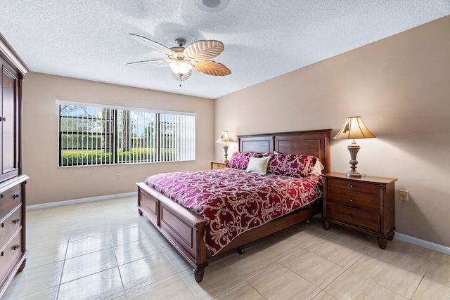 tiled bedroom featuring a textured ceiling and ceiling fan