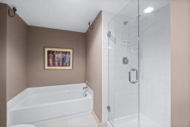 bathroom with tile patterned floors and shower with separate bathtub