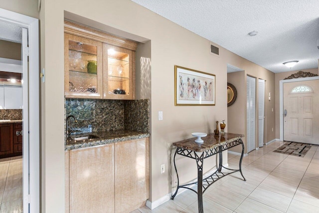 interior space featuring a textured ceiling and sink