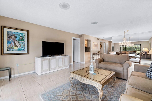 living room featuring light tile patterned flooring, a textured ceiling, and a chandelier