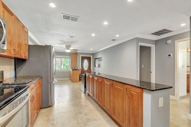 kitchen featuring light tile patterned floors, ceiling fan, stainless steel electric stove, dark stone counters, and crown molding