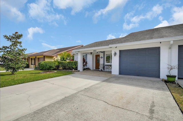 ranch-style home with a front yard and a garage