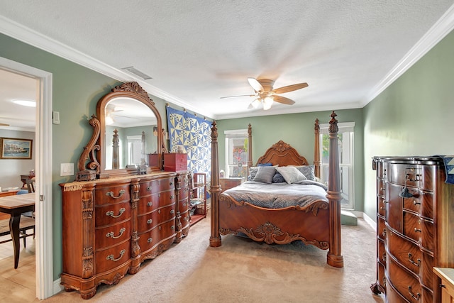 bedroom featuring ceiling fan, light colored carpet, ornamental molding, and a textured ceiling