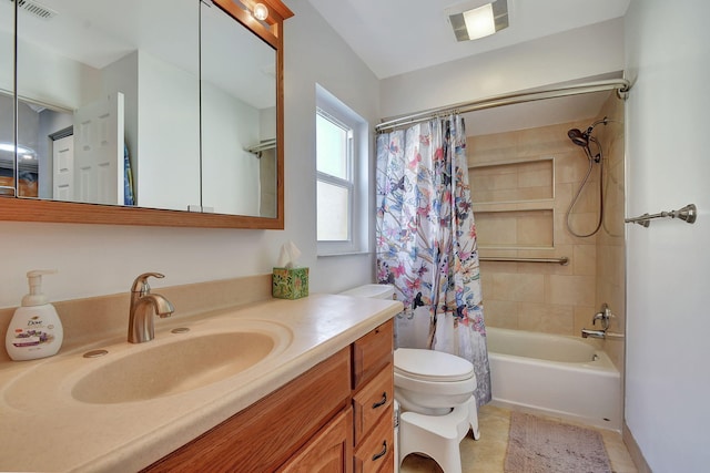 full bathroom featuring toilet, vanity, tile patterned flooring, and shower / bath combo