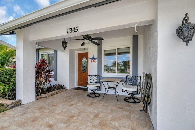 doorway to property with ceiling fan