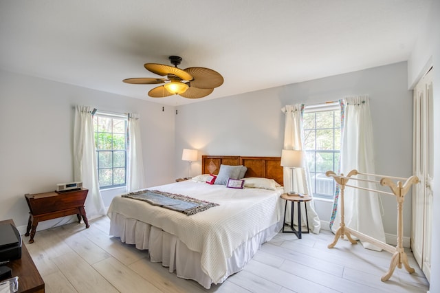 bedroom with ceiling fan and light wood-type flooring