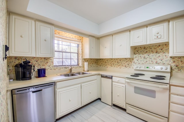 18460 SE Wood Haven Ln Unit D, Jupiter, FL 33469 - kitchen featuring stainless steel dishwasher, white electric stove, wallpapered walls, a sink, and light countertops