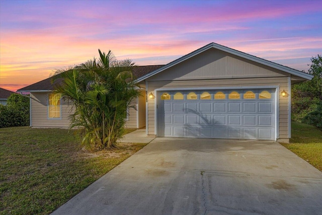 single story home with a garage and a lawn