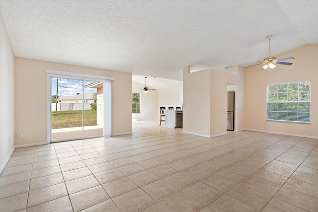 unfurnished living room with light tile patterned flooring, lofted ceiling, a wealth of natural light, and ceiling fan