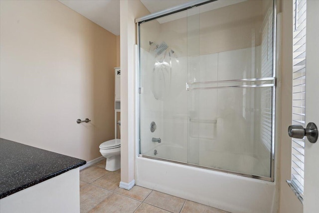 bathroom featuring toilet, tile patterned floors, and shower / bath combination with glass door