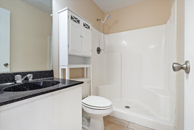 bathroom with vanity, a shower, tile patterned floors, and toilet