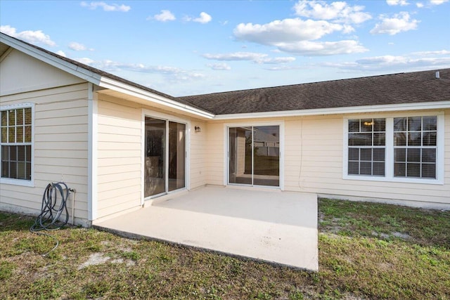 back of house with a yard and a patio area