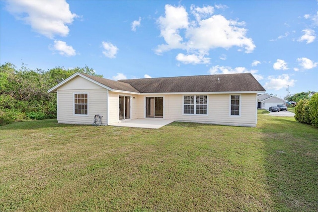 back of house with a yard and a patio area