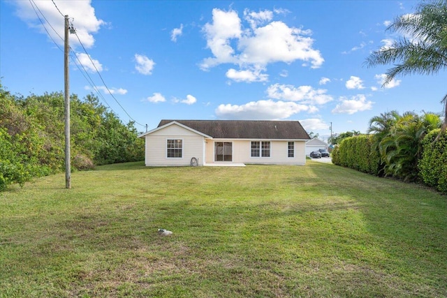 rear view of house with a patio area and a lawn