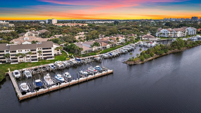 aerial view at dusk featuring a water view