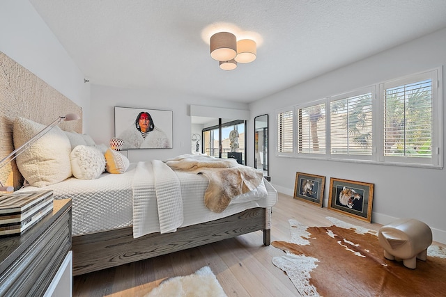 bedroom with hardwood / wood-style floors