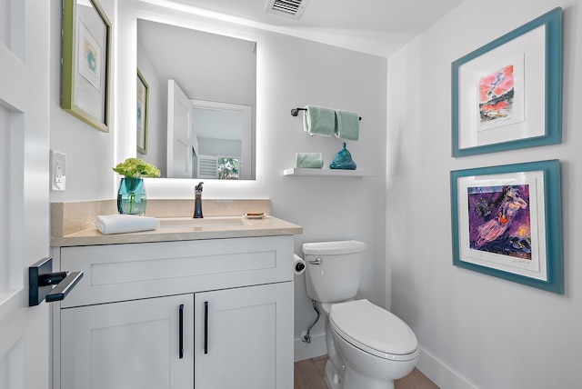 bathroom featuring toilet and vanity