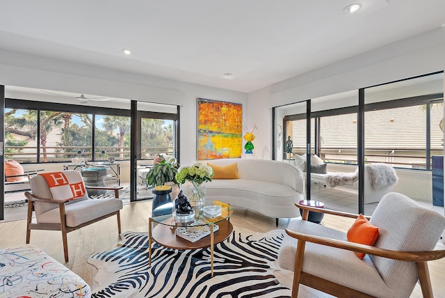 living room featuring ceiling fan and light hardwood / wood-style flooring