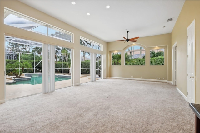 unfurnished sunroom with ceiling fan and plenty of natural light