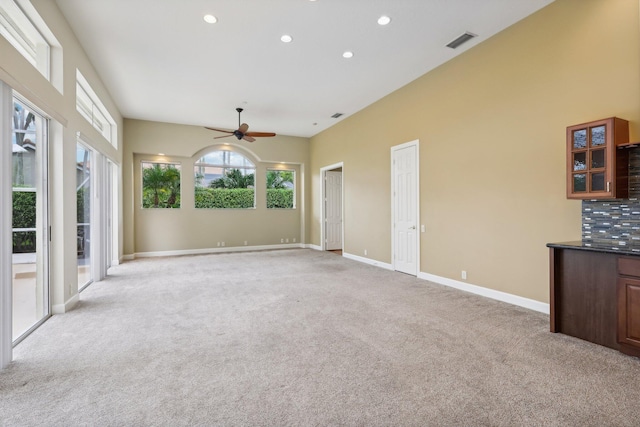 unfurnished living room with ceiling fan and light carpet