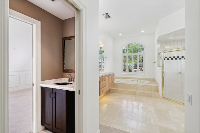 bathroom with tile patterned flooring, independent shower and bath, and vanity