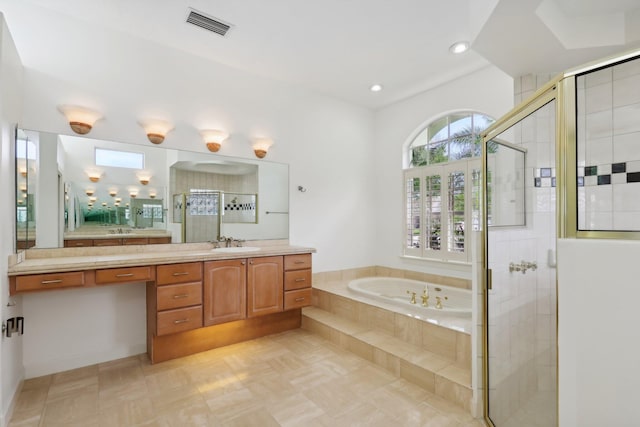 bathroom with plus walk in shower, tile patterned floors, and vanity