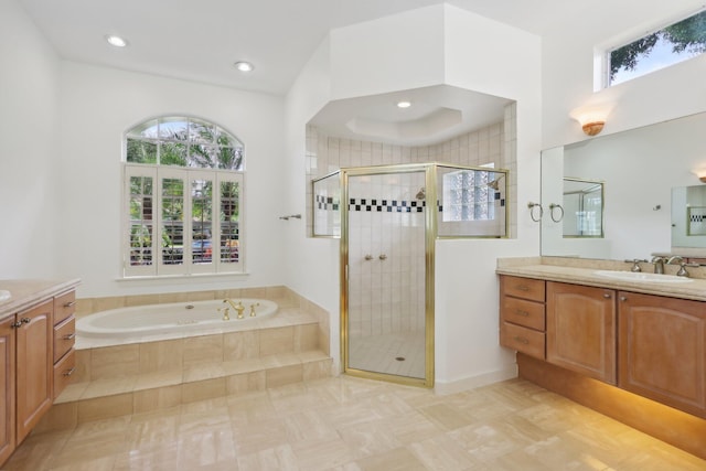 bathroom featuring tile patterned flooring, vanity, and shower with separate bathtub