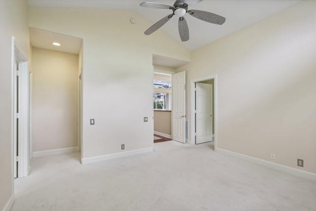 unfurnished bedroom with ceiling fan, light colored carpet, and lofted ceiling