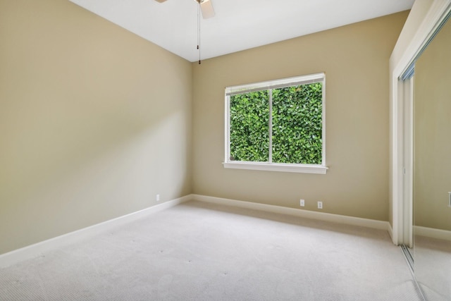 unfurnished bedroom with ceiling fan, a closet, and carpet