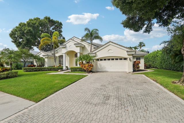 mediterranean / spanish-style house featuring a front yard and a garage