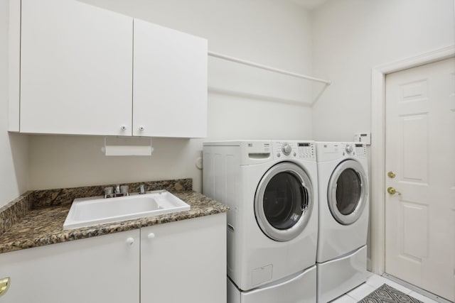 clothes washing area featuring sink, cabinets, independent washer and dryer, and light tile patterned floors