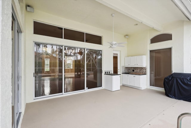 interior space with ceiling fan and a grill