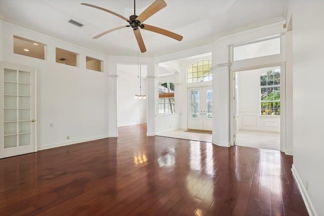 spare room with dark hardwood / wood-style flooring, ceiling fan, crown molding, and built in features