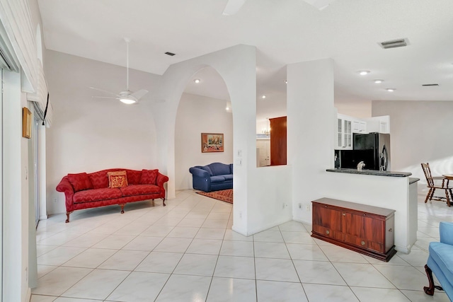 tiled living room with ceiling fan