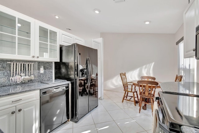 kitchen featuring white cabinets, light stone counters, light tile patterned floors, decorative backsplash, and black appliances