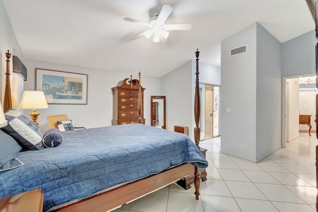 tiled bedroom with lofted ceiling, a textured ceiling, and ceiling fan