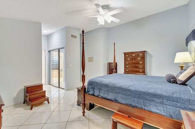 bedroom featuring light tile patterned flooring, a textured ceiling, and ceiling fan