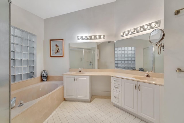 bathroom with independent shower and bath, tile patterned flooring, and vanity