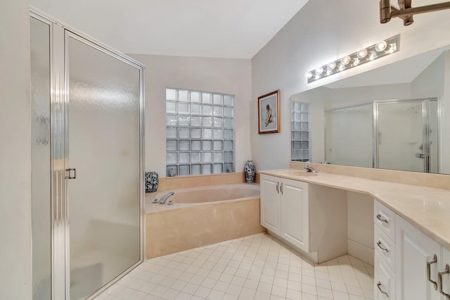 bathroom with tile patterned flooring, independent shower and bath, and vanity