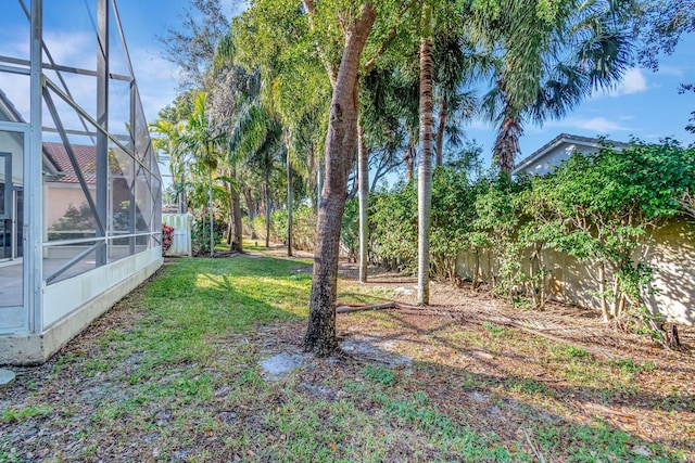 view of yard featuring glass enclosure